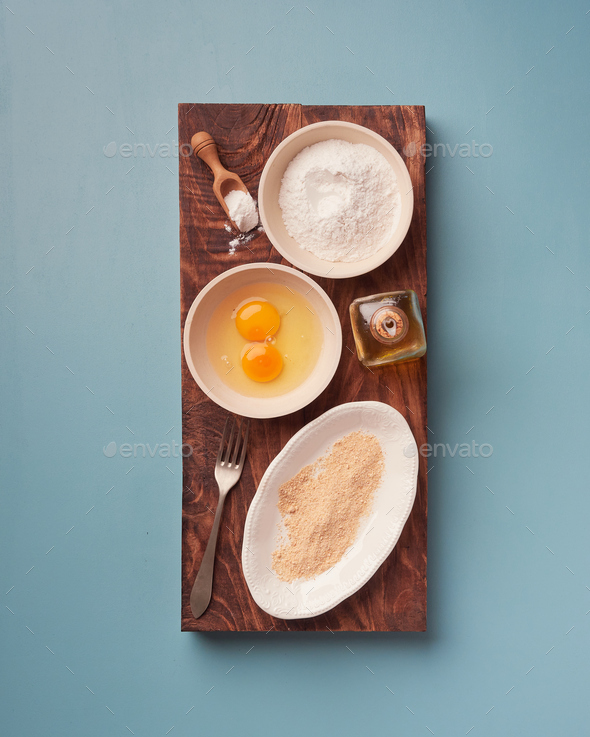 flour, eggs and breadcrumbs, ingredients for breading. Stock Photo by